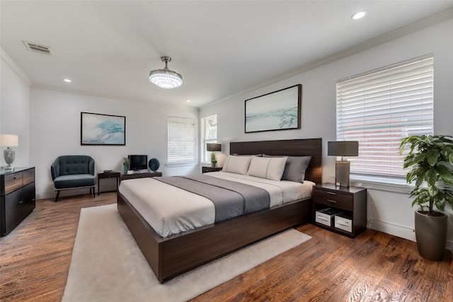 bedroom featuring dark hardwood / wood-style floors and crown molding