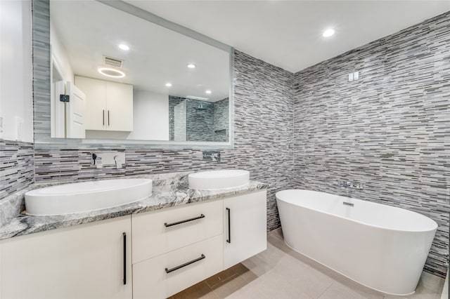 bathroom featuring backsplash, tile patterned flooring, vanity, tile walls, and shower with separate bathtub