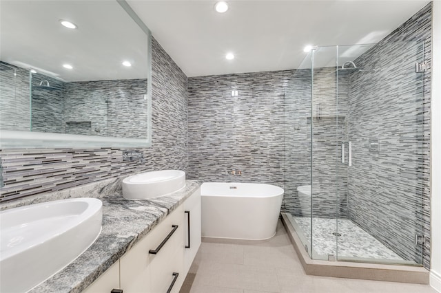 bathroom featuring vanity, tile patterned flooring, separate shower and tub, and tile walls