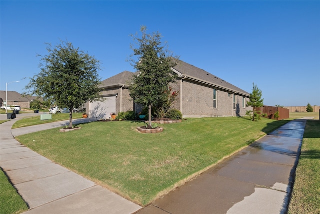 view of front facade with a front lawn and a garage