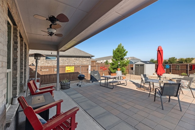 view of patio / terrace featuring ceiling fan and a storage shed