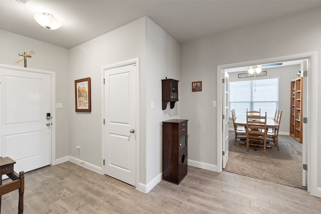 foyer entrance featuring ceiling fan and light hardwood / wood-style floors