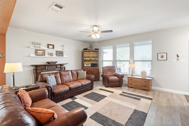 living room with ceiling fan and light hardwood / wood-style flooring