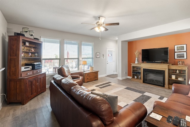 living room with light wood-type flooring and ceiling fan