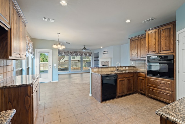 kitchen featuring tasteful backsplash, light tile patterned floors, sink, stone counters, and black appliances