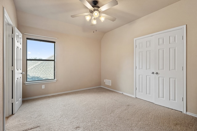 unfurnished bedroom featuring a closet, ceiling fan, and light colored carpet