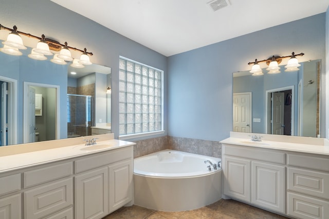 bathroom with tile patterned flooring, plus walk in shower, and vanity