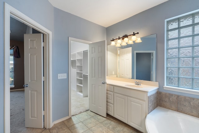 bathroom featuring tile patterned floors, a tub, and vanity