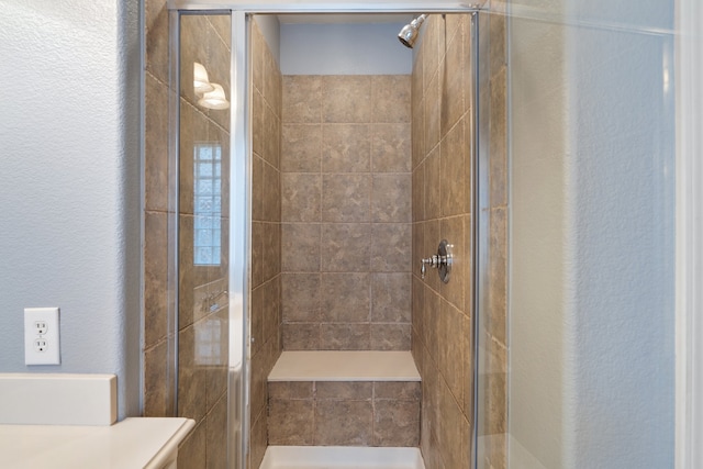 bathroom with a shower with door