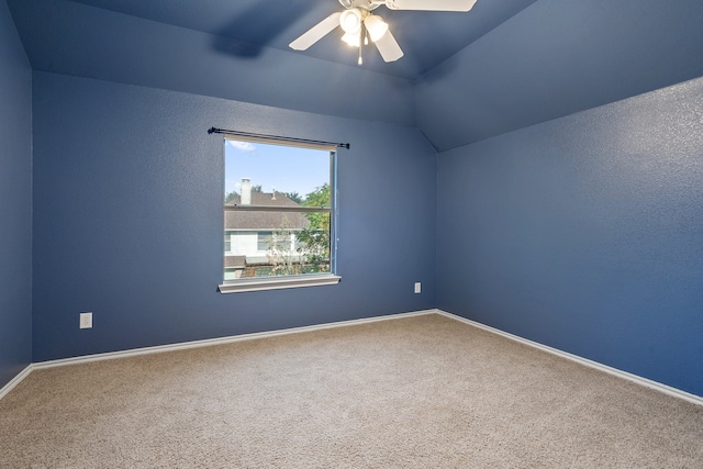 empty room with carpet flooring, ceiling fan, and vaulted ceiling