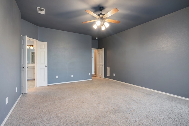 spare room with light colored carpet and ceiling fan