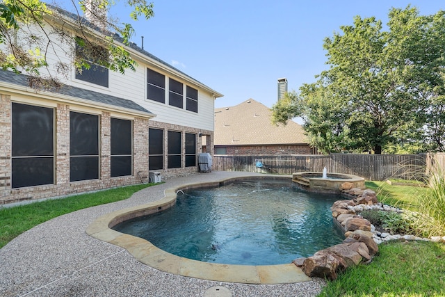 view of swimming pool with an in ground hot tub