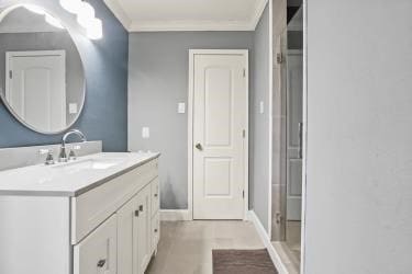 bathroom with ornamental molding, vanity, and tile patterned floors