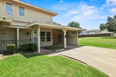 back of house with a lawn