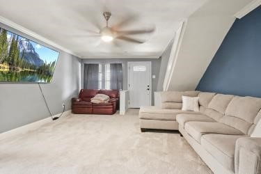 carpeted living room with ceiling fan