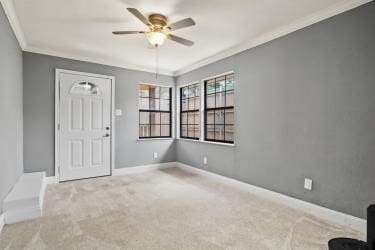 spare room with ceiling fan, ornamental molding, and carpet flooring