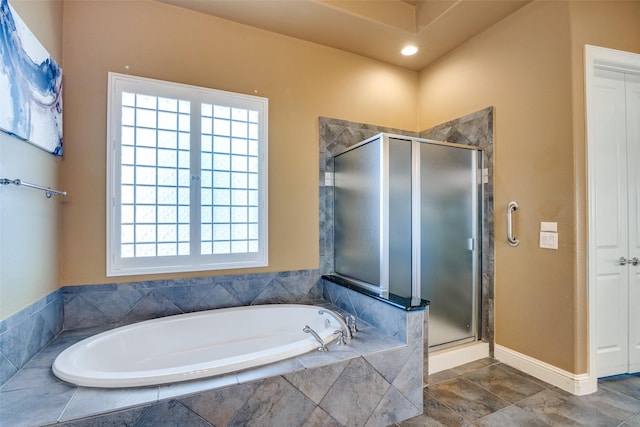 bathroom with a healthy amount of sunlight and shower with separate bathtub