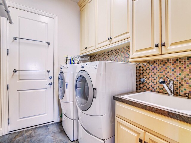 washroom with washer and clothes dryer, sink, and cabinets