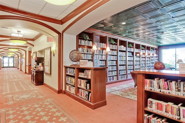 hall featuring carpet flooring and ornamental molding