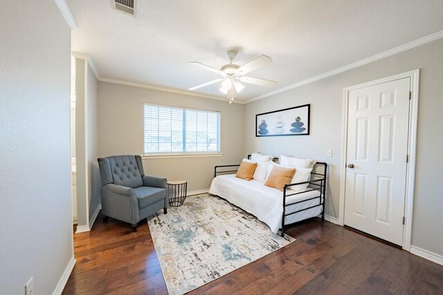 bedroom featuring ceiling fan, ornamental molding, and dark hardwood / wood-style flooring