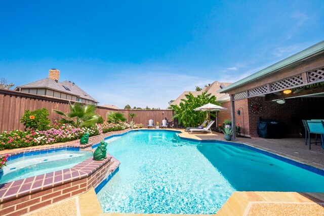 view of swimming pool featuring an in ground hot tub and a patio area