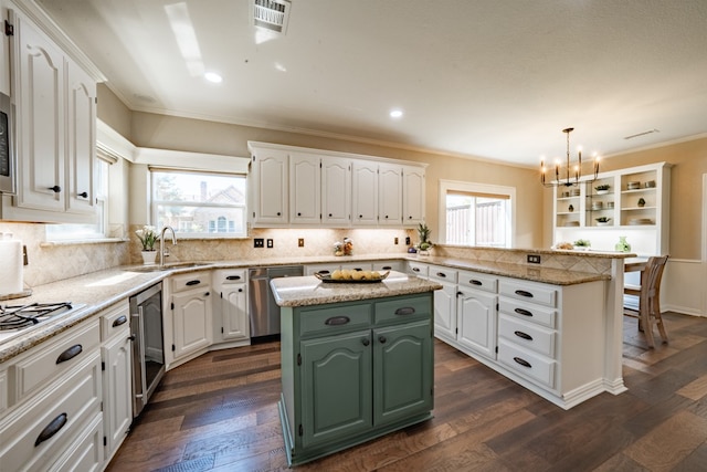 kitchen featuring a wealth of natural light, a center island, and white cabinetry