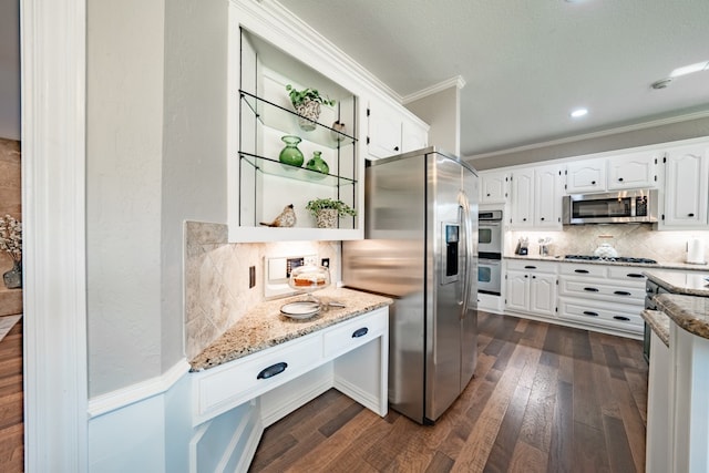 kitchen with stainless steel appliances, dark hardwood / wood-style floors, tasteful backsplash, crown molding, and white cabinets