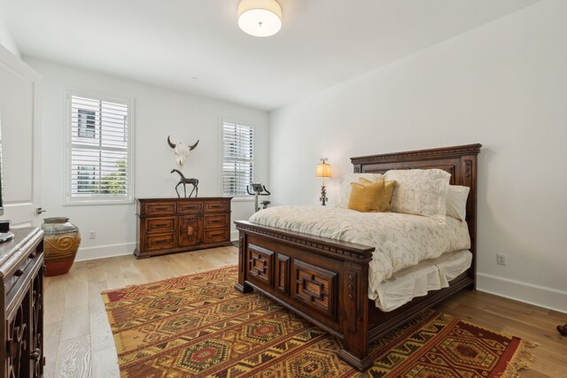 5270 Town And Country Blvd Unit 113, Frisco, TX 75034 - bedroom with light wood-type flooring and baseboards