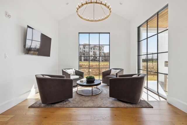 5270 Town And Country Blvd Unit 113, Frisco, TX 75034 - living area with light wood-type flooring, an inviting chandelier, and a healthy amount of sunlight