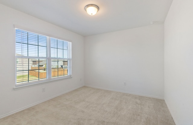 unfurnished room featuring light colored carpet