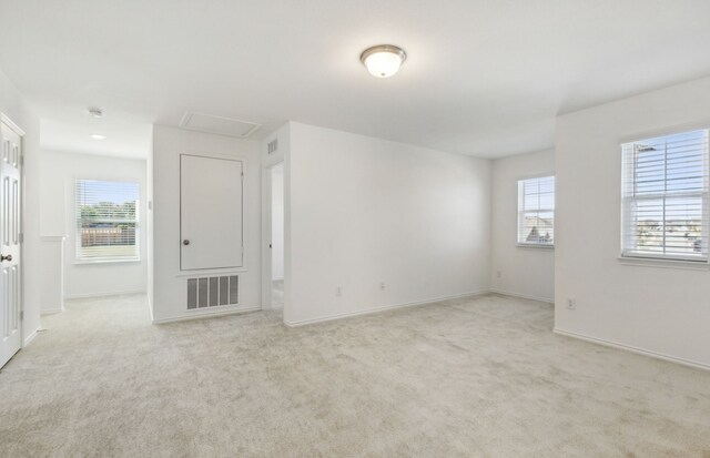 unfurnished room with light carpet and a wealth of natural light