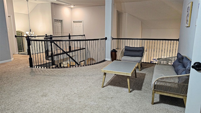 living area featuring an inviting chandelier, lofted ceiling, and carpet flooring