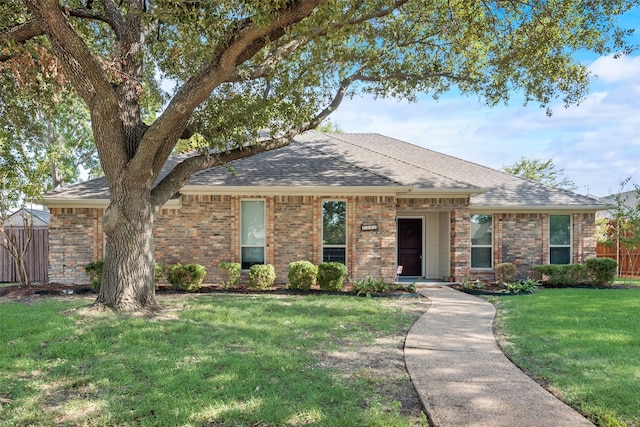 ranch-style home featuring a front yard