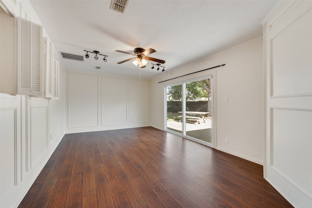 empty room featuring ceiling fan, track lighting, hardwood / wood-style flooring, and crown molding