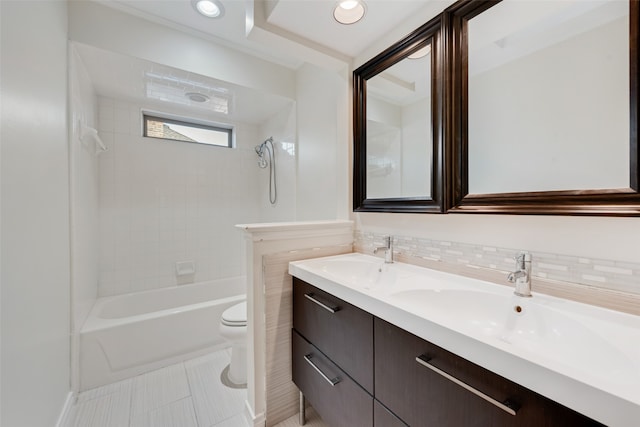 full bathroom with backsplash, vanity, tile patterned floors, tiled shower / bath, and toilet