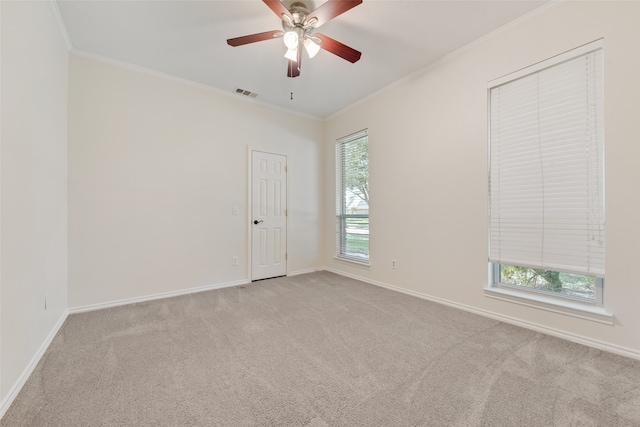 unfurnished room with ceiling fan, ornamental molding, and light colored carpet