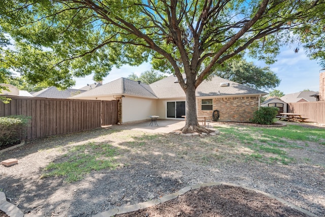 back of house with a patio