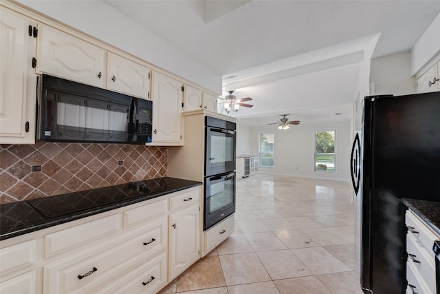 kitchen featuring backsplash, black appliances, light tile patterned floors, ceiling fan, and dark stone countertops