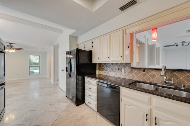 kitchen with ceiling fan, dark stone counters, tasteful backsplash, sink, and black appliances