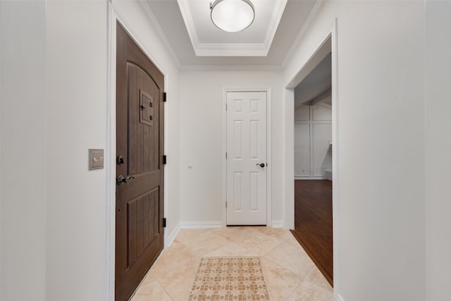 tiled entryway featuring ornamental molding