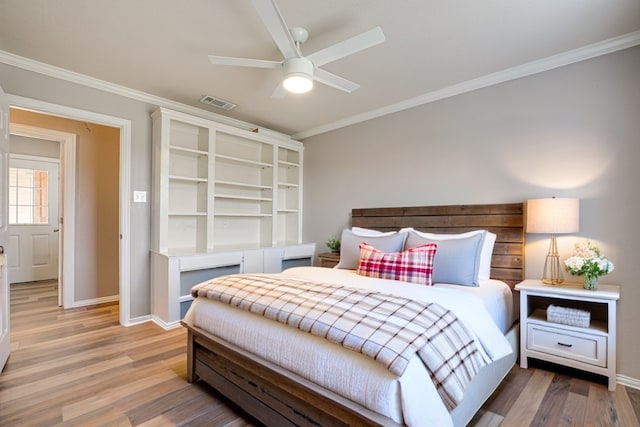 bedroom featuring hardwood / wood-style floors, ceiling fan, and crown molding