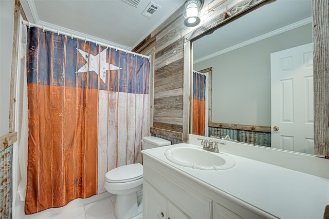 bathroom with vanity, toilet, ornamental molding, and tile patterned floors