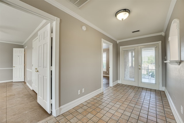 foyer entrance with ornamental molding, french doors, and light tile patterned floors