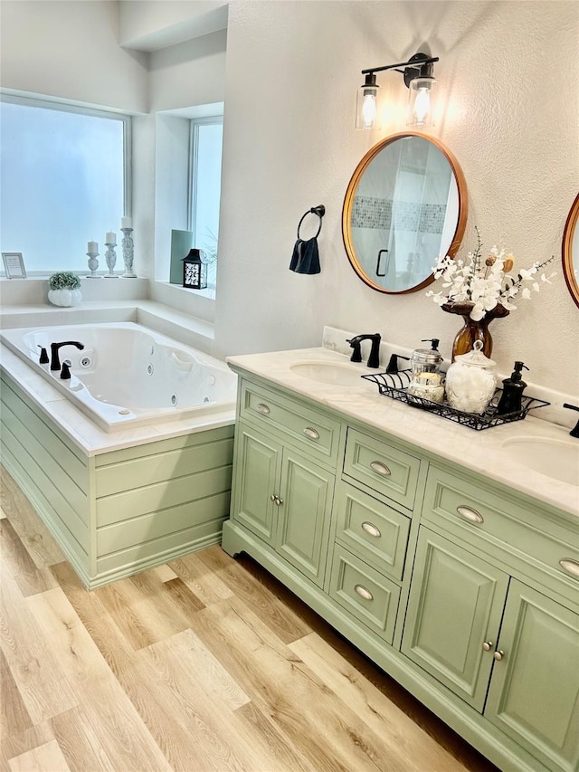 bathroom with a bath, wood-type flooring, and vanity