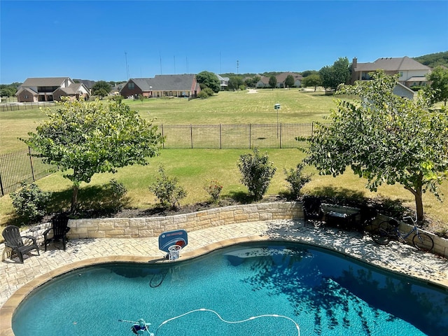 view of pool with a lawn