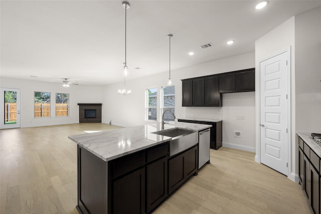 kitchen with a kitchen island with sink, sink, plenty of natural light, and dishwasher