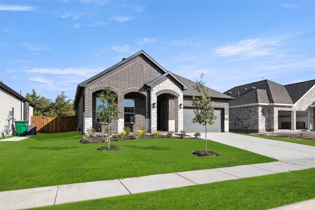 french country style house with a front yard and a garage