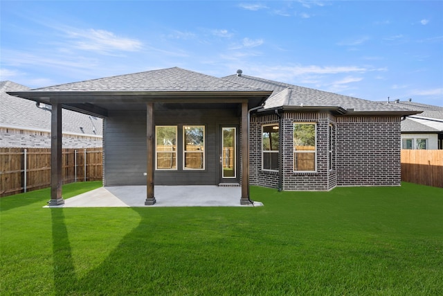 rear view of property with a patio area and a lawn