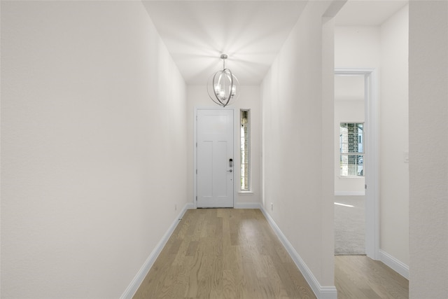 entryway with a chandelier and light wood-type flooring