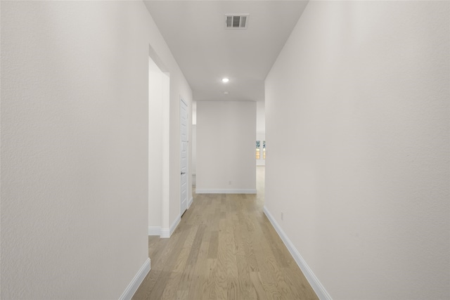 corridor featuring light hardwood / wood-style floors